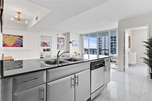 kitchen featuring visible vents, a chandelier, dishwasher, light tile patterned floors, and a sink