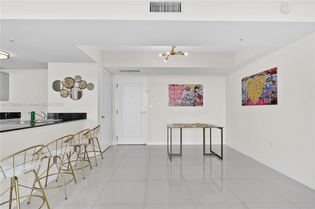 interior space featuring tile patterned floors, baseboards, and visible vents