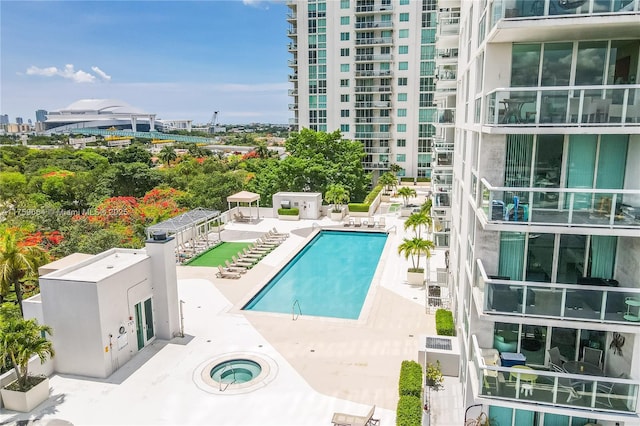 community pool with a city view and a patio area