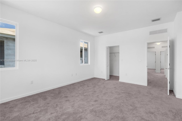 unfurnished bedroom featuring baseboards, visible vents, and carpet floors