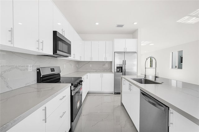 kitchen with light stone counters, visible vents, a sink, stainless steel appliances, and marble finish floor