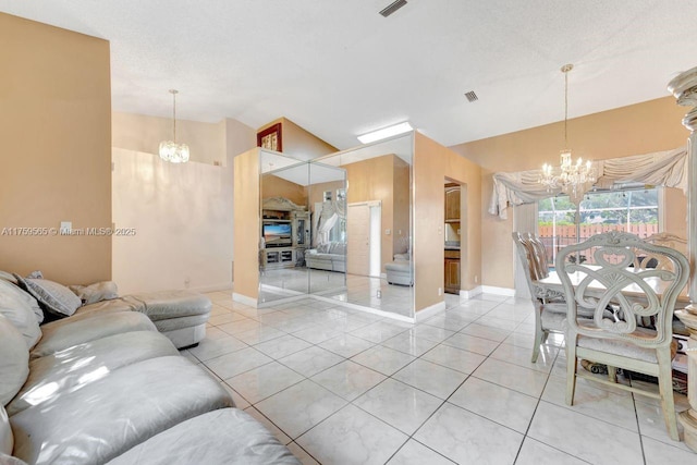 living area with a notable chandelier, visible vents, and light tile patterned floors