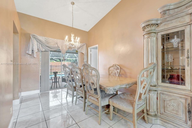 dining room featuring lofted ceiling, a notable chandelier, baseboards, and light tile patterned floors