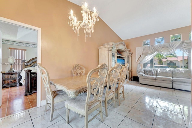 dining room with a notable chandelier, light tile patterned floors, and high vaulted ceiling