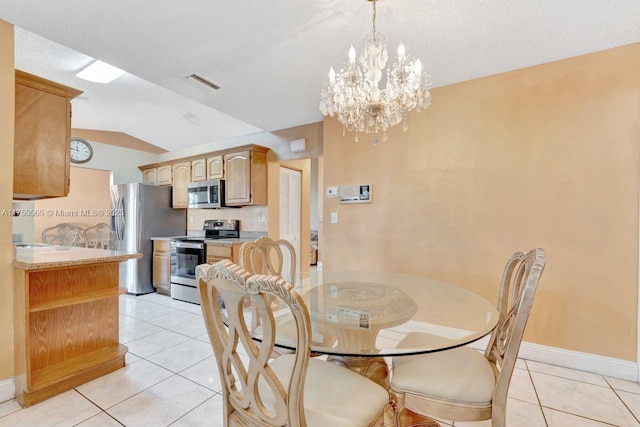 dining room featuring light tile patterned floors, visible vents, lofted ceiling, and baseboards