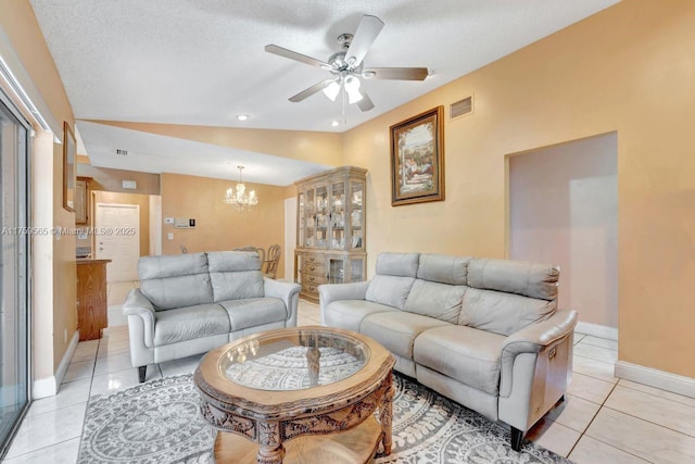 living room with visible vents, baseboards, lofted ceiling, light tile patterned floors, and a textured ceiling