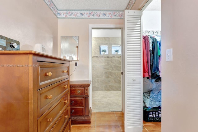 interior space featuring a textured ceiling and walk in shower