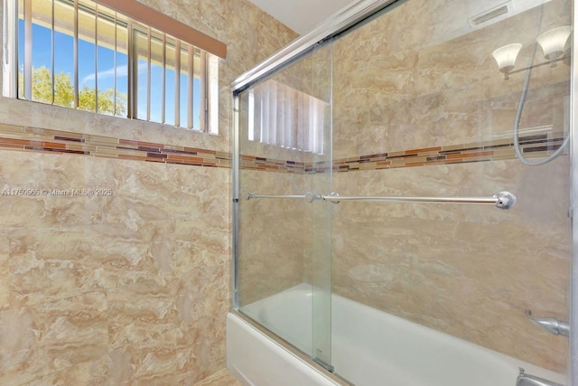 full bathroom with shower / bath combination with glass door