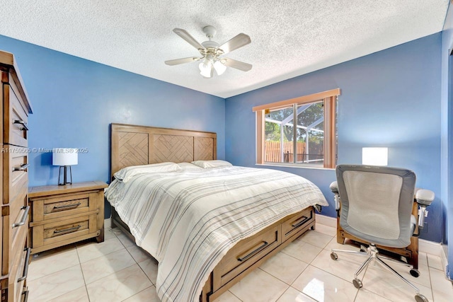 bedroom with light tile patterned flooring, baseboards, and a textured ceiling