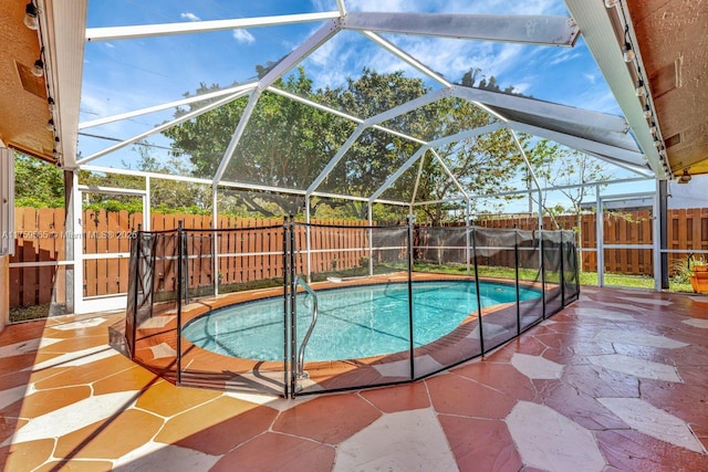 view of swimming pool featuring a lanai, a fenced in pool, a fenced backyard, and a patio area