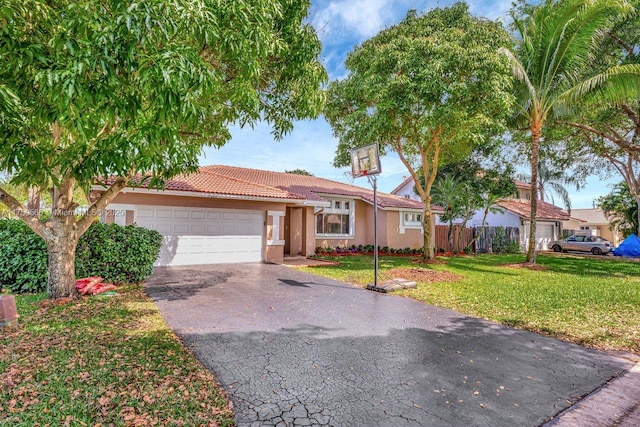 single story home with a front lawn, fence, aphalt driveway, stucco siding, and an attached garage