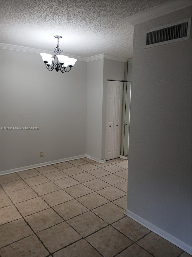 spare room with visible vents, crown molding, baseboards, an inviting chandelier, and a textured ceiling