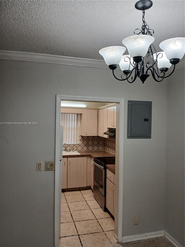 kitchen featuring electric range, a notable chandelier, electric panel, under cabinet range hood, and dark countertops