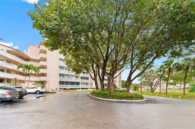 view of building exterior featuring uncovered parking