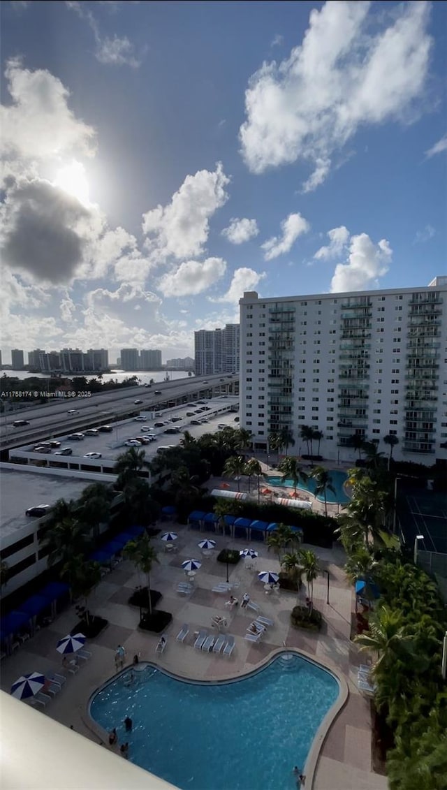 view of swimming pool featuring a city view