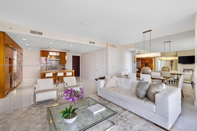 living area with recessed lighting and visible vents