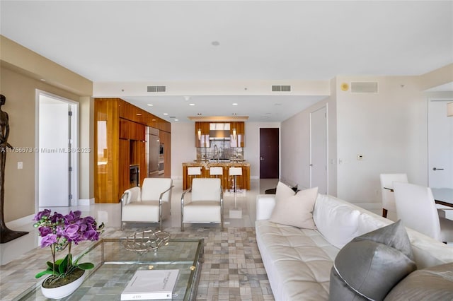 living area with visible vents and recessed lighting