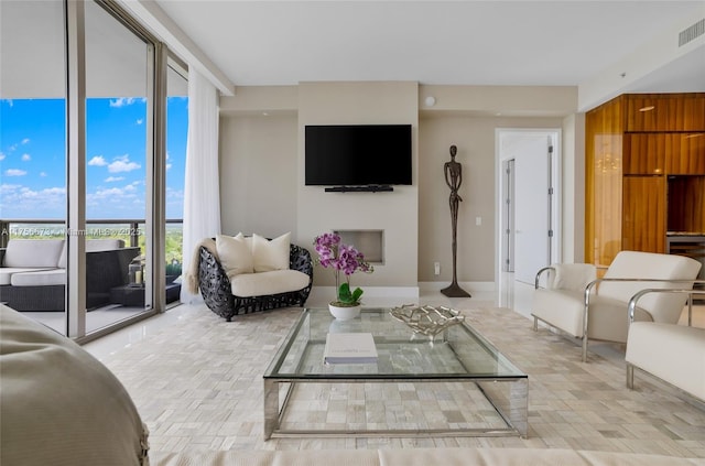 living area with a wall of windows and visible vents