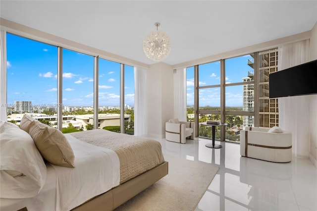 bedroom featuring a city view, multiple windows, an inviting chandelier, and expansive windows