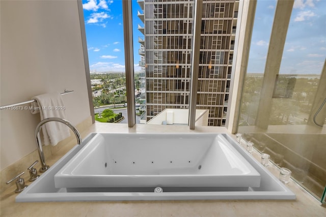 full bathroom with a tub with jets