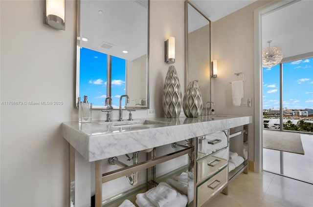 bathroom with a sink, visible vents, and double vanity