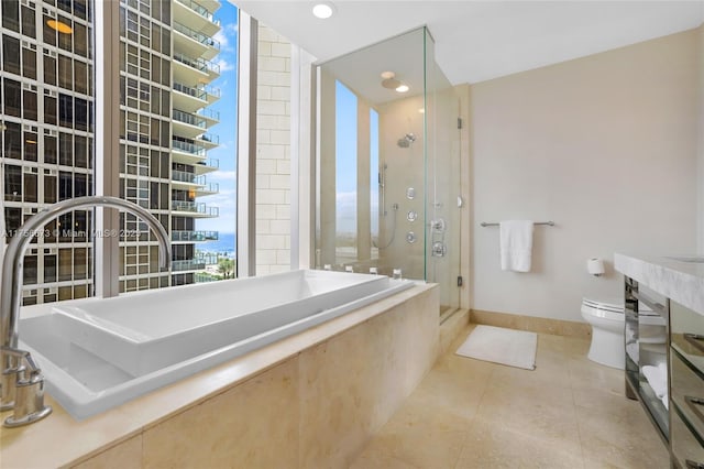 full bathroom featuring toilet, a shower stall, tile patterned flooring, baseboards, and a bath