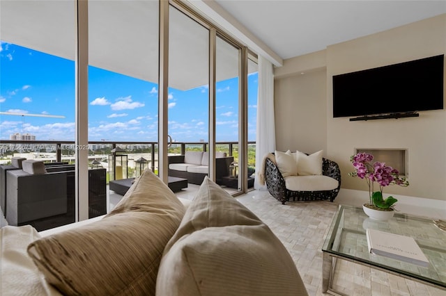 living room with floor to ceiling windows and baseboards