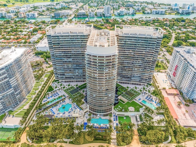 birds eye view of property with a water view and a view of city