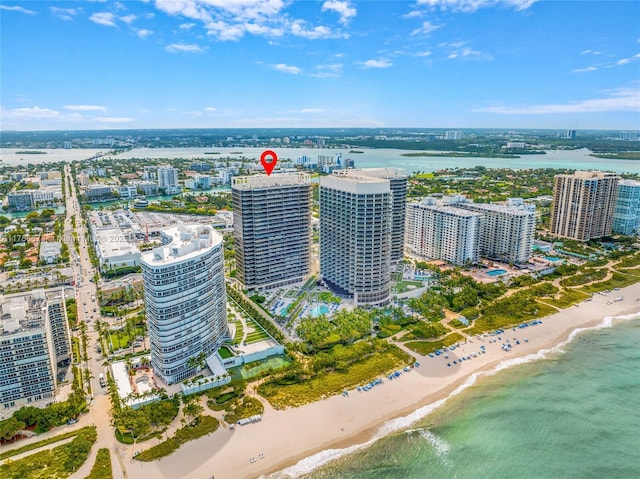 bird's eye view with a water view, a city view, and a view of the beach