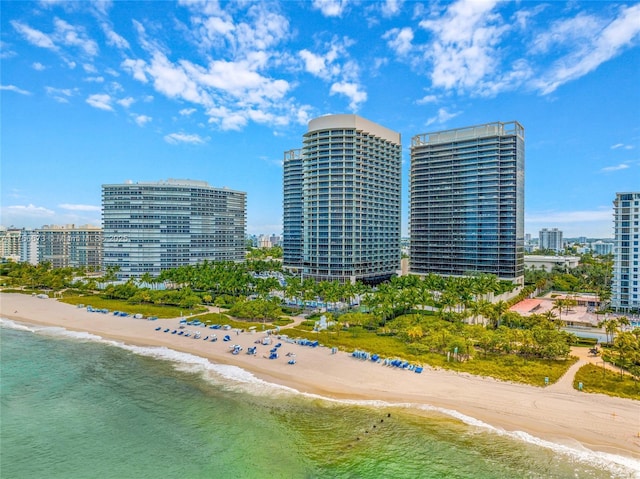 birds eye view of property featuring a view of city, a beach view, and a water view