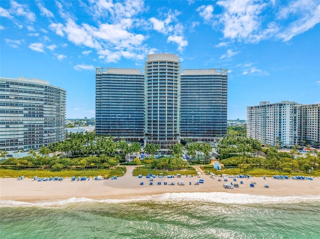 view of property with a city view, a beach view, and a water view