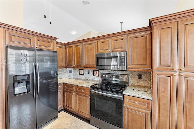 kitchen featuring light tile patterned floors, decorative backsplash, stainless steel appliances, and lofted ceiling