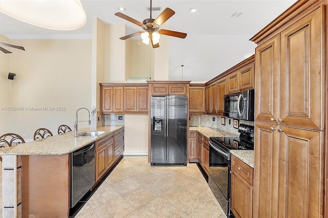 5523 NW 57th Ter, Coral Springs, FL 33067 - kitchen featuring black appliances, a ceiling fan, a sink, a peninsula, and brown cabinetry