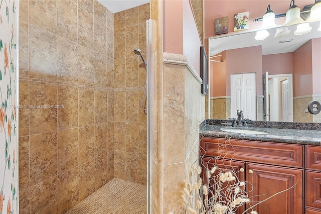 bathroom featuring vanity, a shower stall, and visible vents