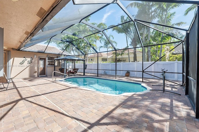 view of pool with a lanai, a fenced in pool, a patio area, and fence