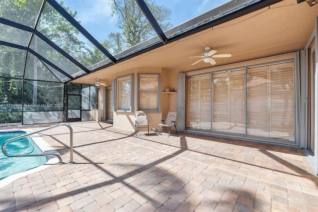 unfurnished sunroom featuring ceiling fan