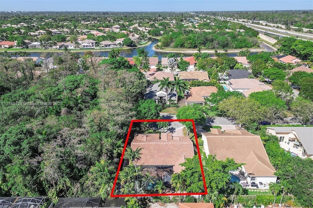 drone / aerial view with a residential view and a water view