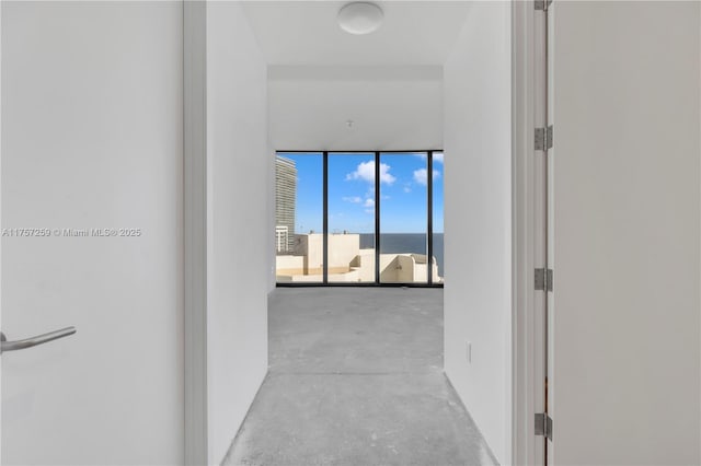 hallway with expansive windows and concrete floors