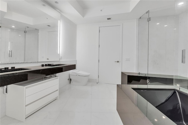 full bathroom with visible vents, toilet, a tray ceiling, a shower stall, and vanity