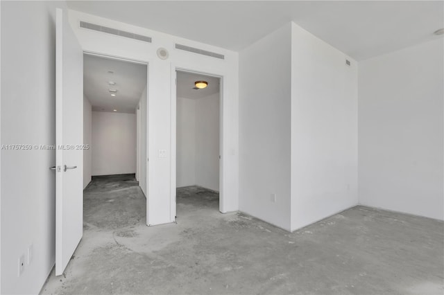 unfurnished room featuring visible vents and concrete floors