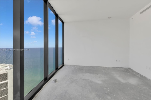 unfurnished room featuring floor to ceiling windows and concrete flooring