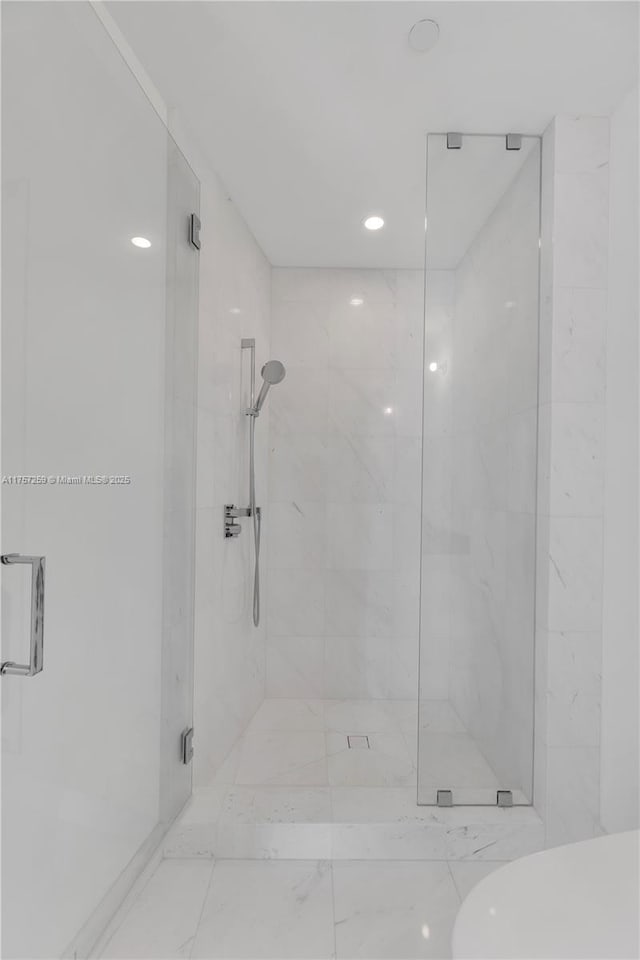 bathroom with a marble finish shower