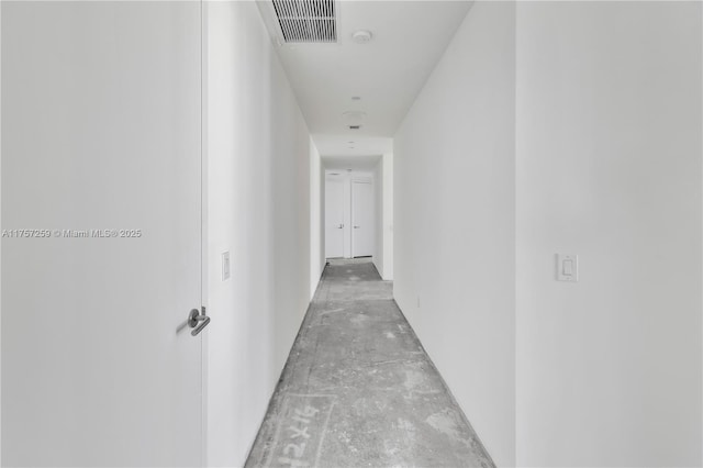 corridor featuring visible vents and concrete flooring