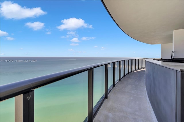 balcony with a water view and a sink