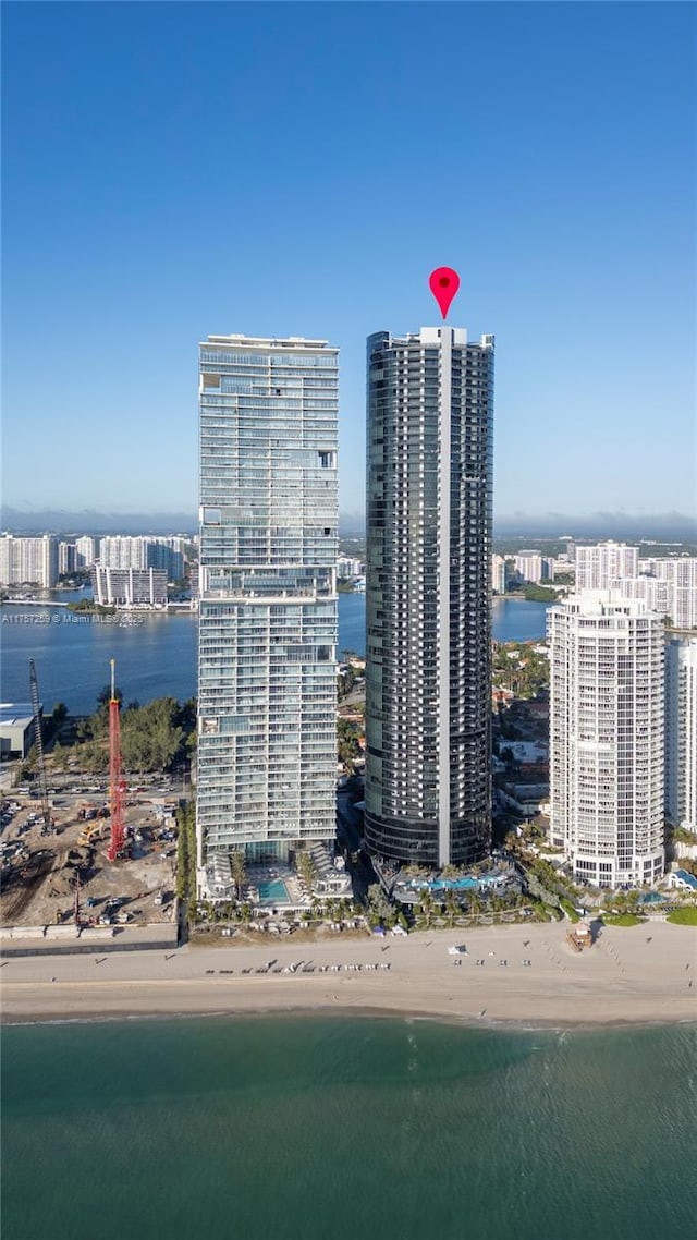 birds eye view of property featuring a city view, a beach view, and a water view