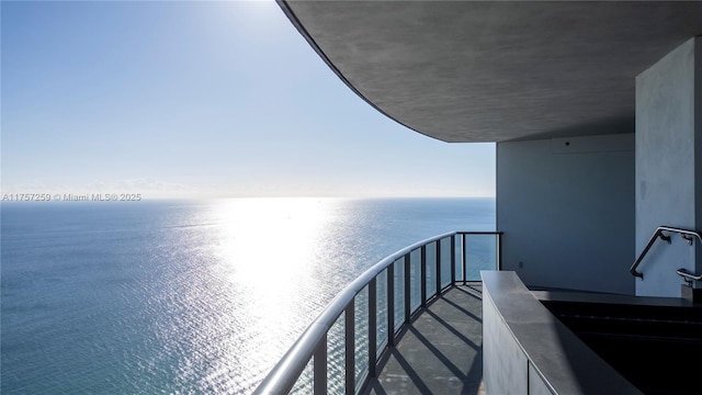 balcony with a sink and a water view