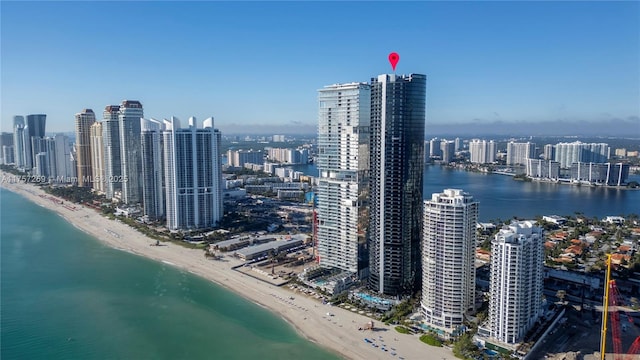 birds eye view of property with a view of the beach, a view of city, and a water view