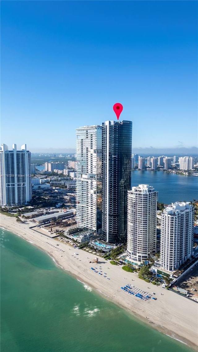 birds eye view of property featuring a view of city, a beach view, and a water view