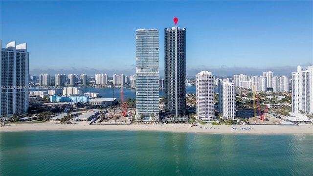 property's view of city with a water view and a view of the beach