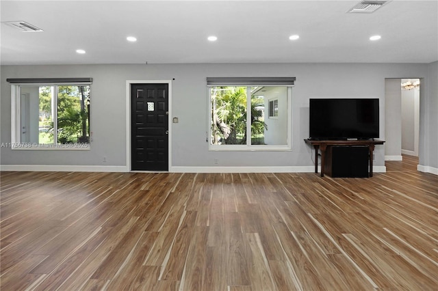 unfurnished living room featuring recessed lighting, visible vents, and a healthy amount of sunlight